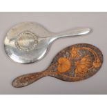 A Pokerwork hand mirror with floral decoration, along with a silver plate hand mirror.