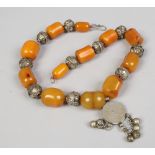 An Eastern white metal and amber coloured bead necklace, possibly Saudi Arabian.
