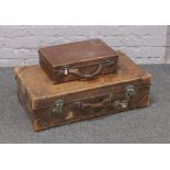 A vintage good quality leather suitcase with leather bound corners monogrammed F.E.B, along with a