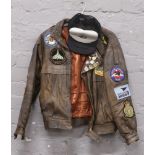 A leather flying jacket, medium size with 16 embroidered patches mainly relating to The Vulcan