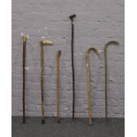 A bundle of six walking sticks including thumb stick.