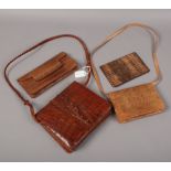 A vintage alligator handbag, along with one similar and two snakeskin clutch bags.