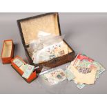 A wooden box of loose stamps to include mostly Australian examples.
