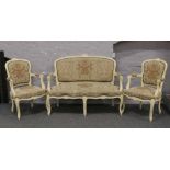 A French cream painted salon suite with floral upholstery raised on cabriole legs.