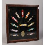 A cased display of Varga collectors knives, each decorated with the original Varga girl pinups.