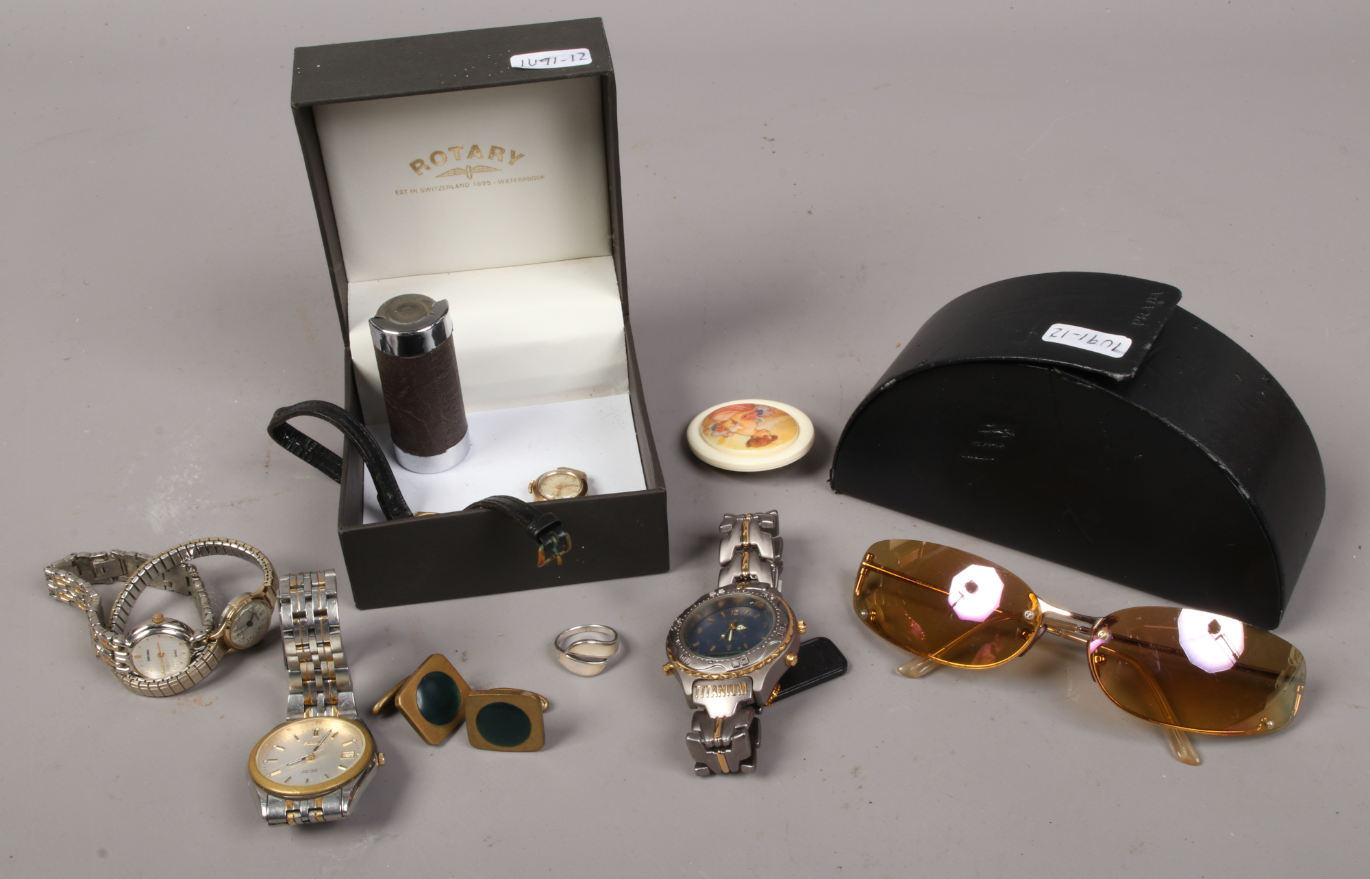 A small quantity of accessories and costume jewellery to include manual wristwatch, Prada sunglasses