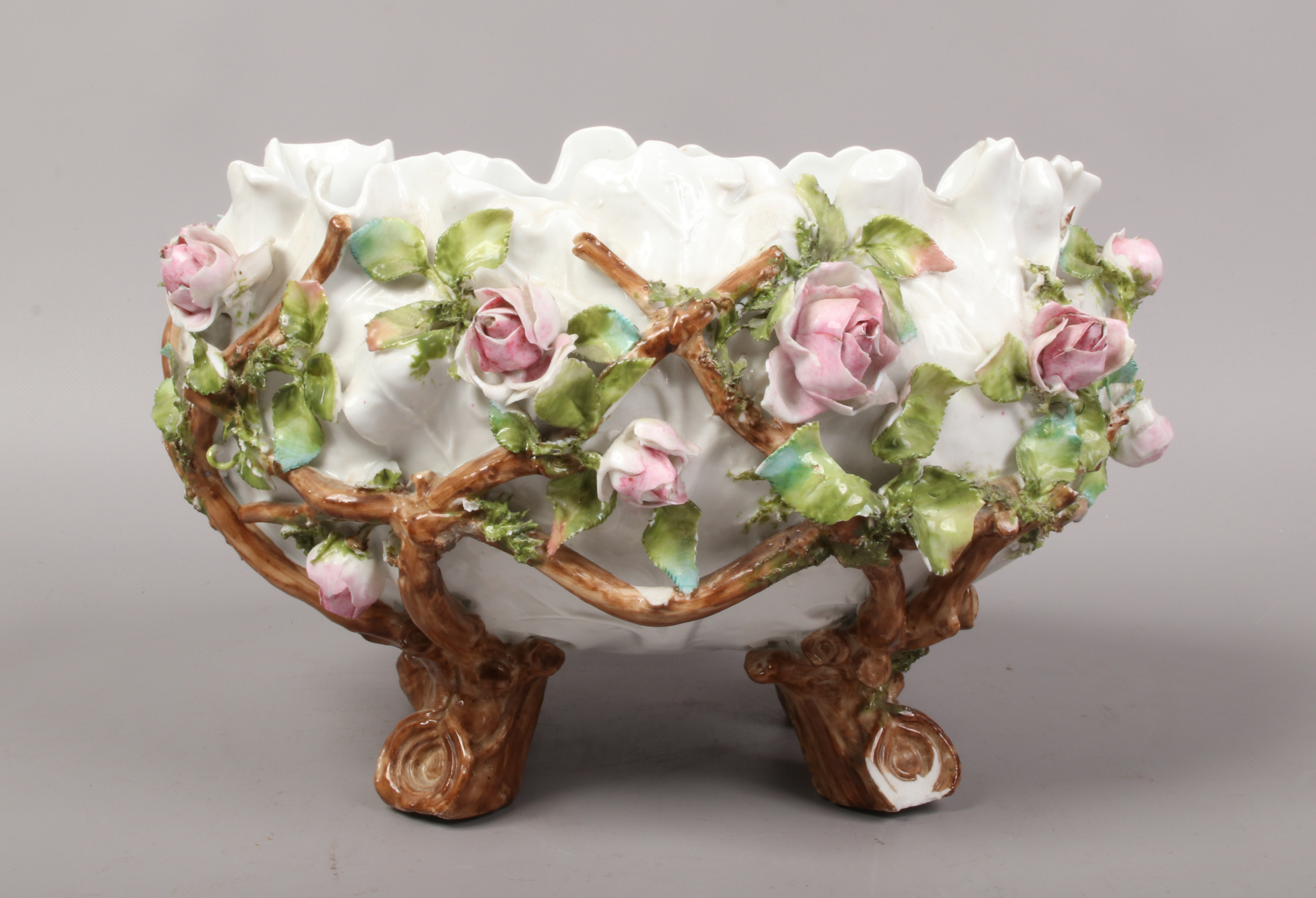 A Meissen style poise bowl decoration with applied flowers, cross sword mark to base.