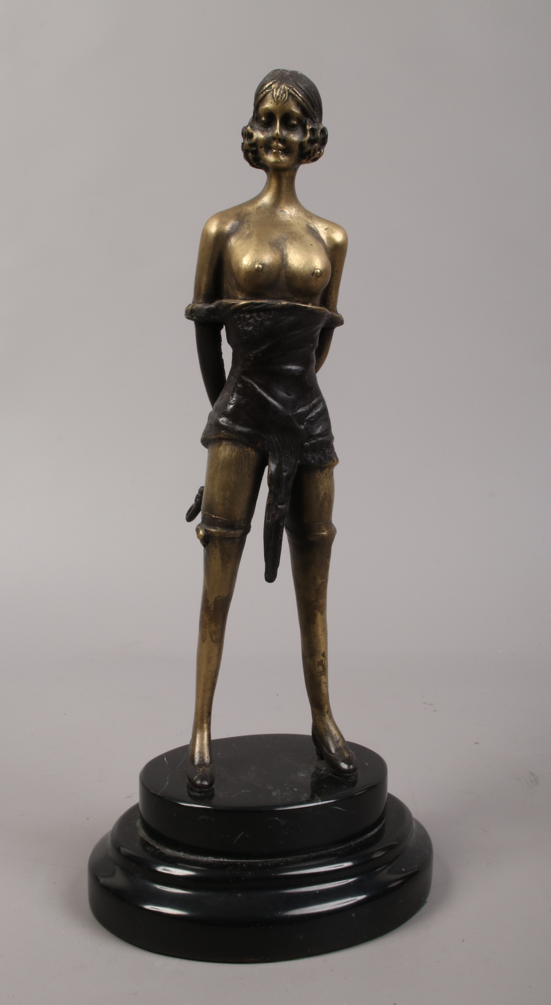 A decorative bronze of a semi clad female, signed F. Preiss raised on stepped marble base.