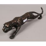 A bronze study of a prowling Cheetah.