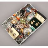 A tin of various collectables including vintage costume brooches, Chinese snuff bottle, cased