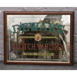 A framed Dewar's Scotch Whisky advertising mirror.