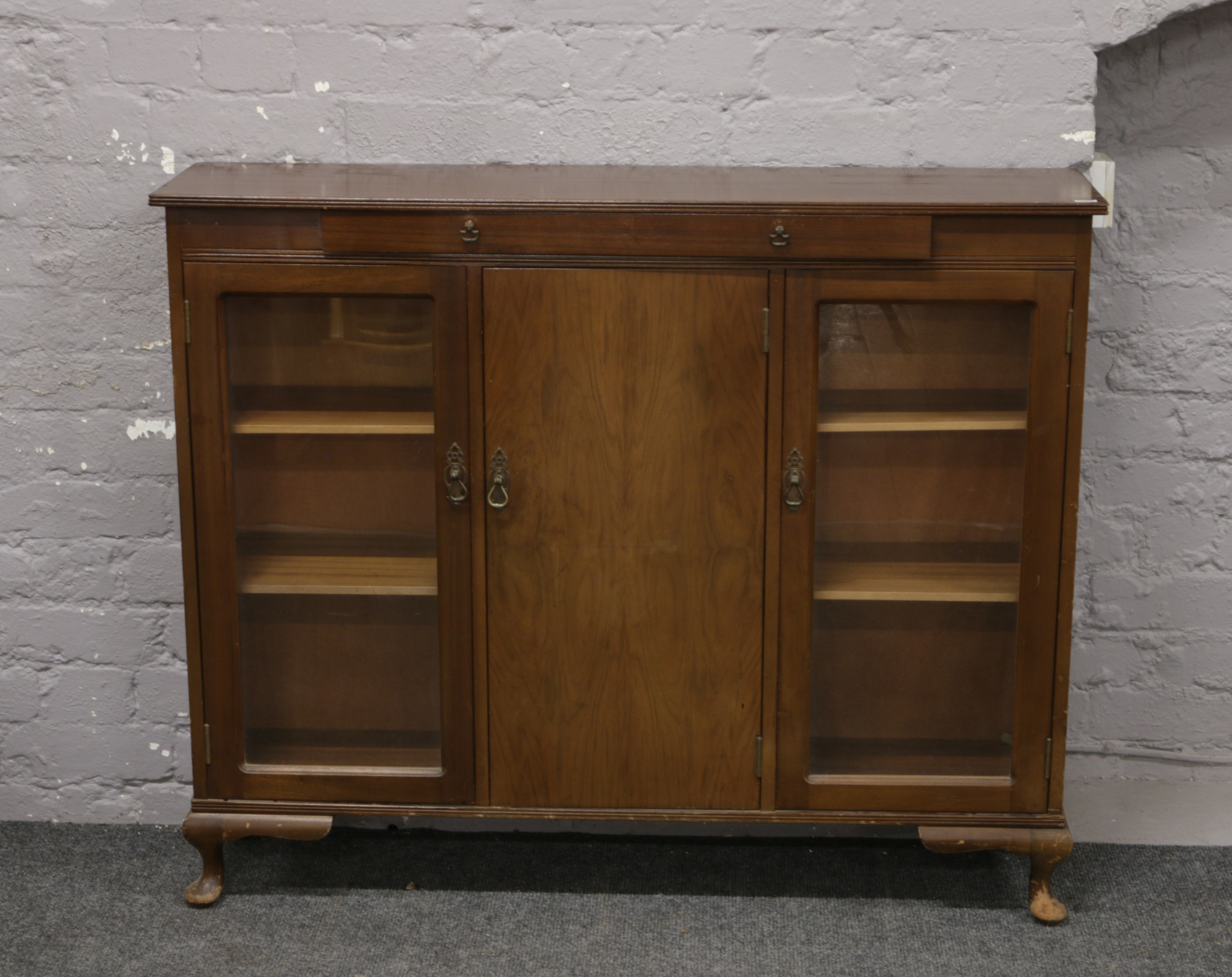 A mahogany display cabinet on cabriole supports.