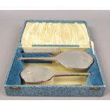 A cased silver mounted four piece dressing table set, assayed Birmingham 1954.