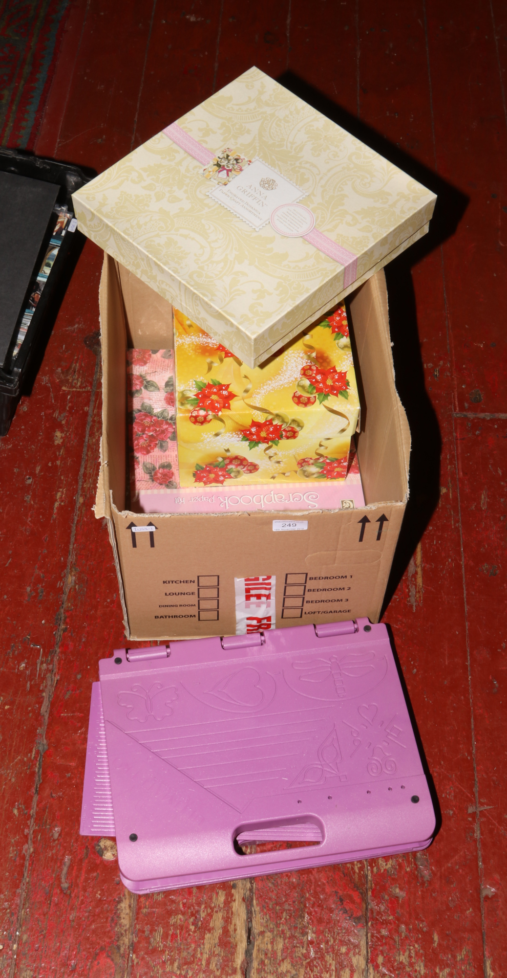 A box of crafting items to include scrap books, ultimate pro crafters companion etc.