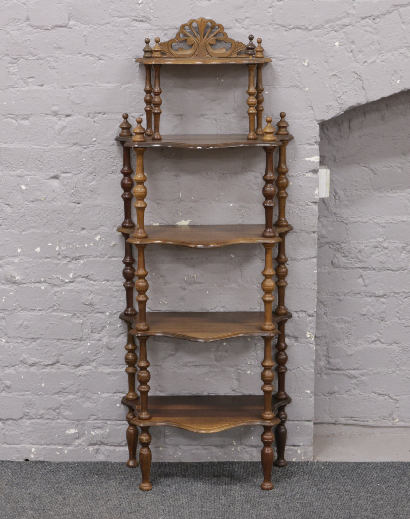 A mahogany 5 tier whatnot stand raised on turned supports.