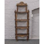 A mahogany 5 tier whatnot stand raised on turned supports.