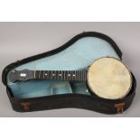 A vintage cased banjolele.Condition report intended as a guide only.In need of repair.