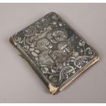 An Edwardian silver mounted motor trip notebook, the front with repousse decoration depicting