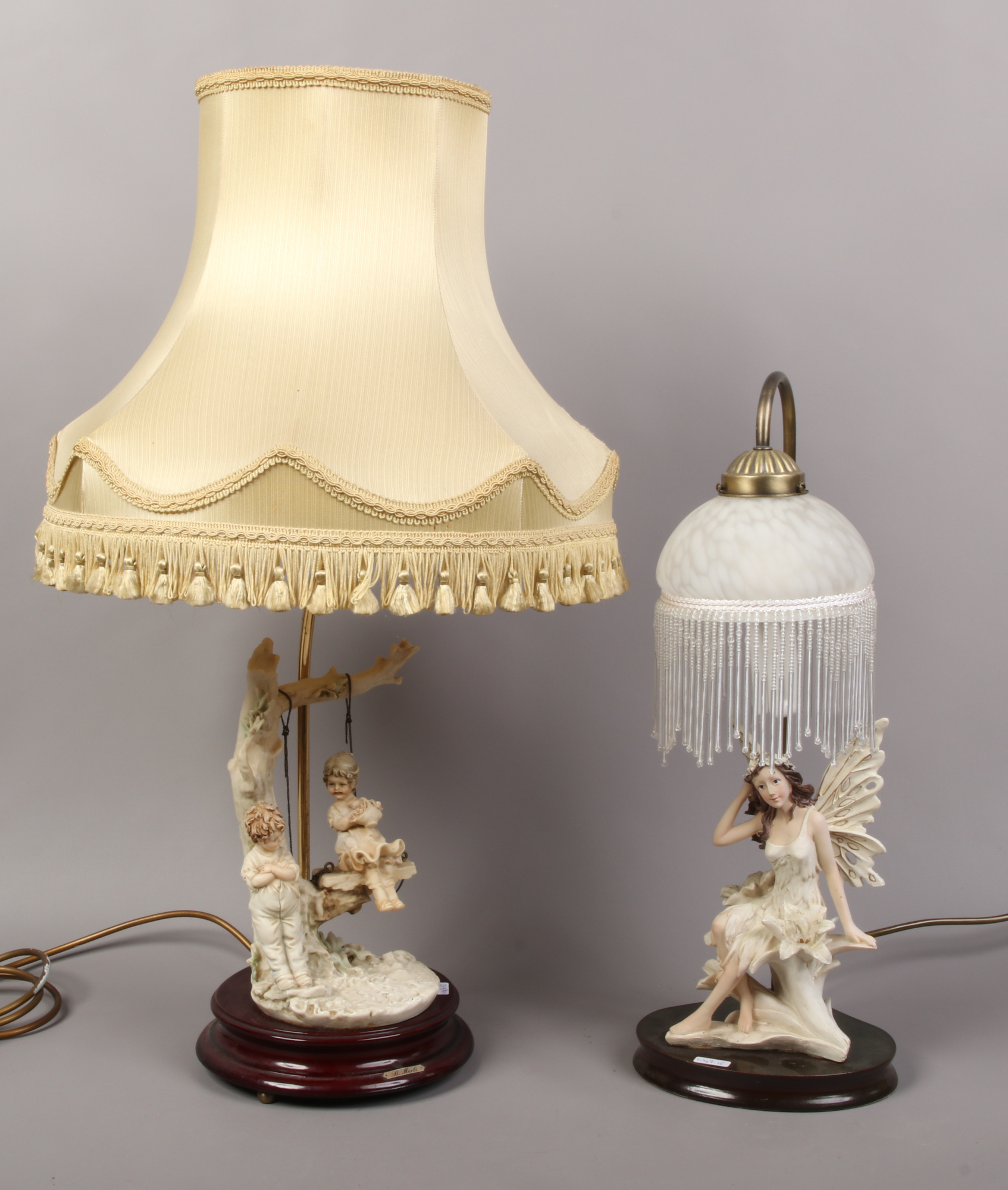 Two figural table lamps, one formed as a child swing and a fairy.