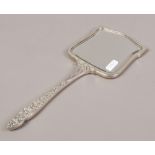 A silver hand mirror with machine turned engraving and floral decoration, assayed Birmingham 1965,