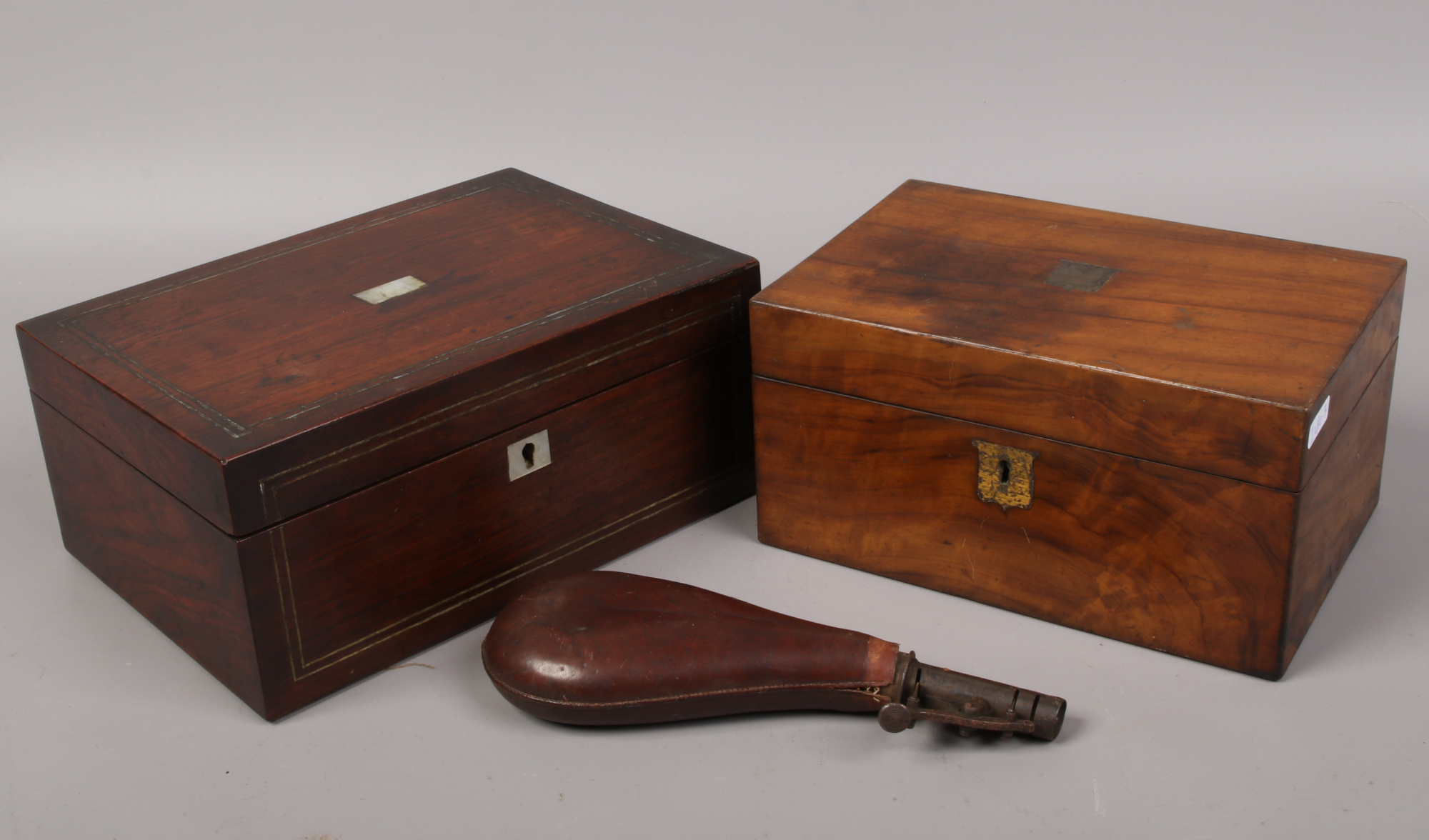 Two Victorian wooden boxes including a mother of pearl inset example, along with a leather mounted