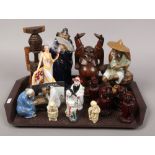 A quantity of oriental figures including carved hardwood Buddha, clay model of sages etc, along with