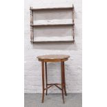 A mahogany wall mounted open bookcase along with a X frame side table.