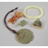 A box of jade and hardstone including bangle, pierced pendant, seated Buddha and two elephants.