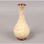 A Moorcroft ivory ground baluster vase hand painted with trailing sepia bands, 16.5cm tall.Condition