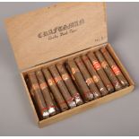 A wooden cigar box containing 24 Karel - Half Corona cigars.