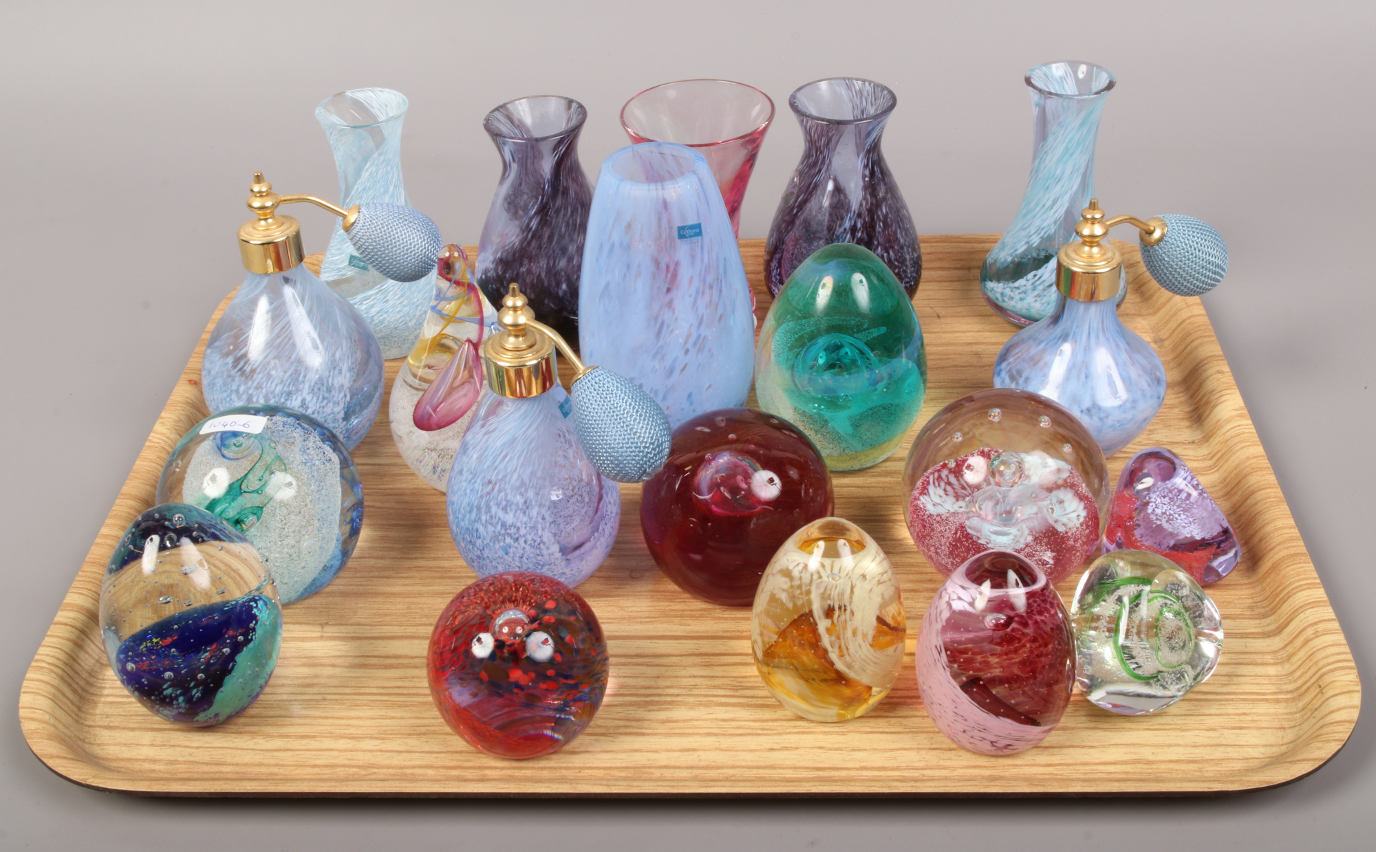 A tray of coloured glass art vases, paper weights and perfume atomisers to include Caithness