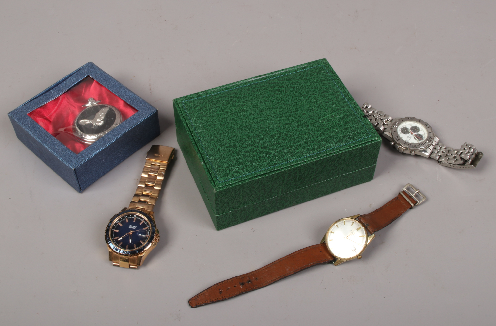 An empty Rolex box, along with three wristwatches and a pocket watch including a Seiko manual