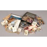 A box of costume jewellery beads, brooches, earrings etc.