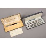A cased Parker 51 propelling pencil, along with a cased brushed stainless steel Parker 25 pen trio.
