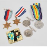 Four World War II medals, a Great War Peace medal and a German Night Fighters badge.