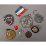 A quantity of medals and badges including British World War II war medal, Service Beyond Self, along