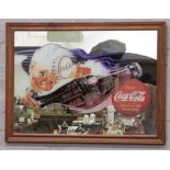 A framed Coca Cola advertising wall mirror.