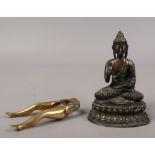 A bronze figure of Buddha, along with a novelty set of brass nut crackers by Peerage.