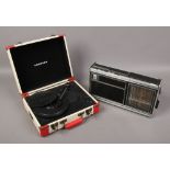 A Grundig concert 1100 portable radio and a Crosley retro style portable record player.