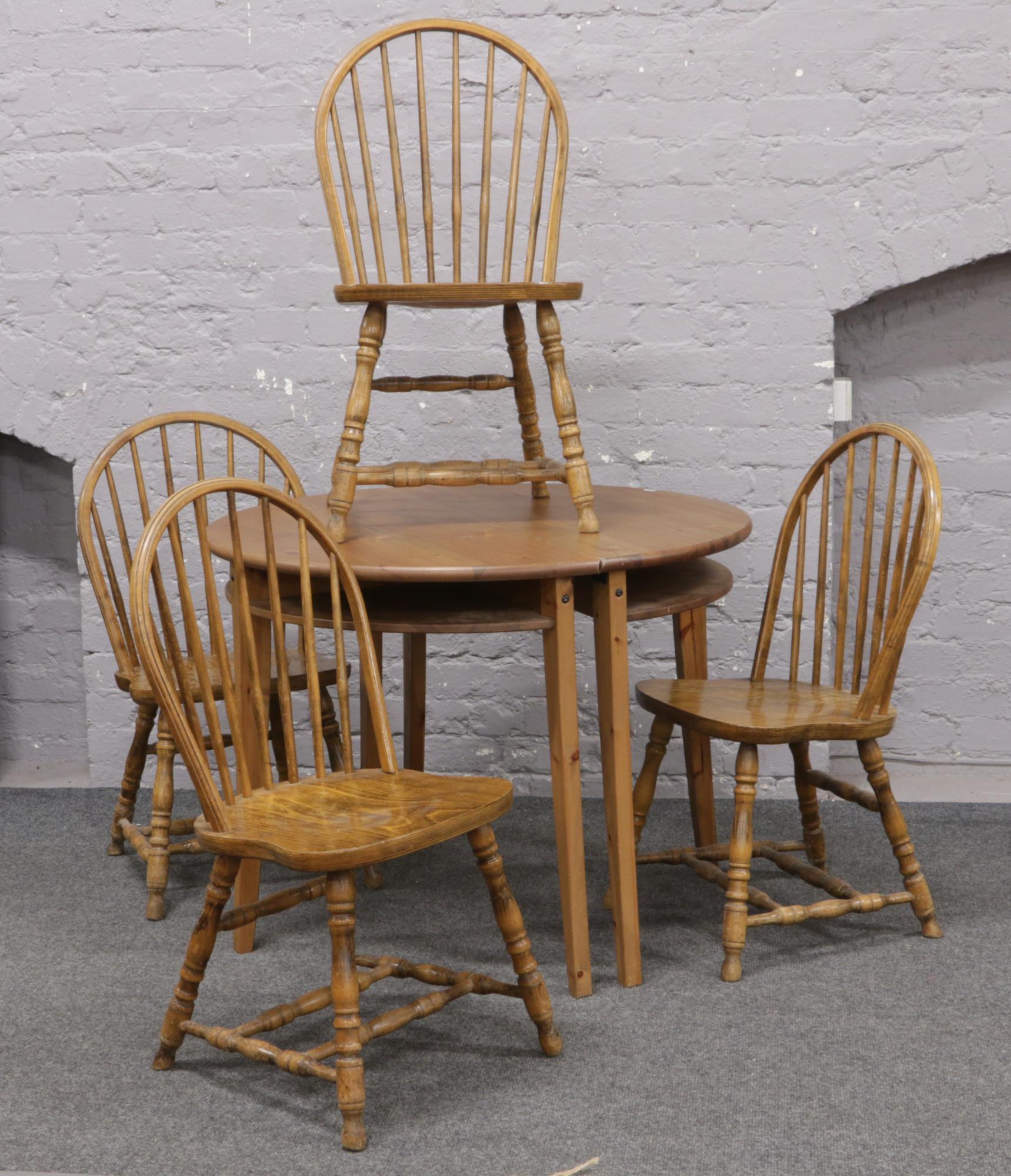 Two Ikea pine demi lune Laurila tables, along with a set of four oak spindle back chairs.