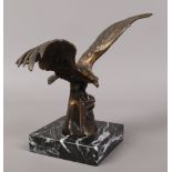 A bronzed spelter model of an eagle, raised on marble base.