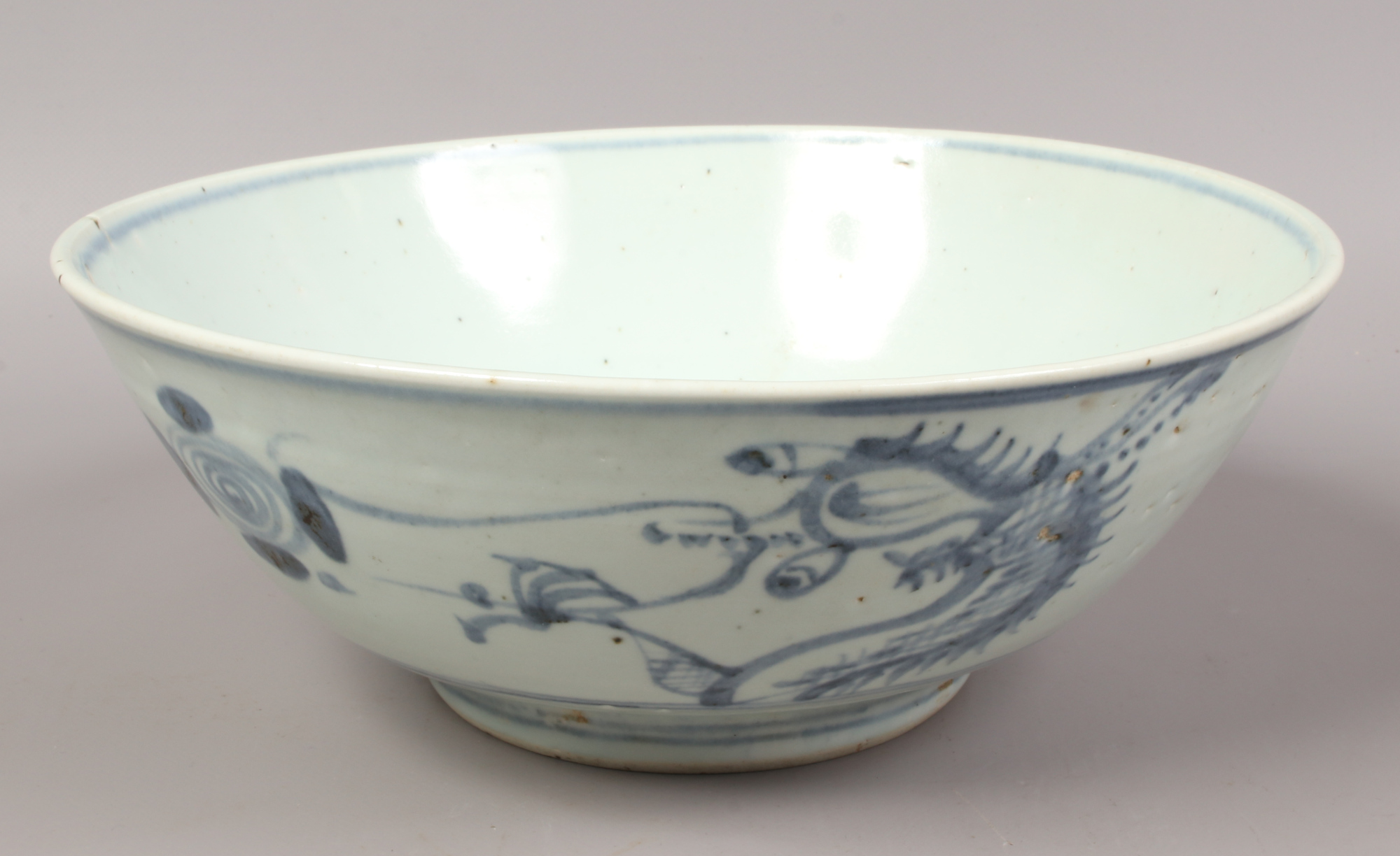 A Chinese Swatow ware bowl probably 17th century painted in underglaze blue with dragons and