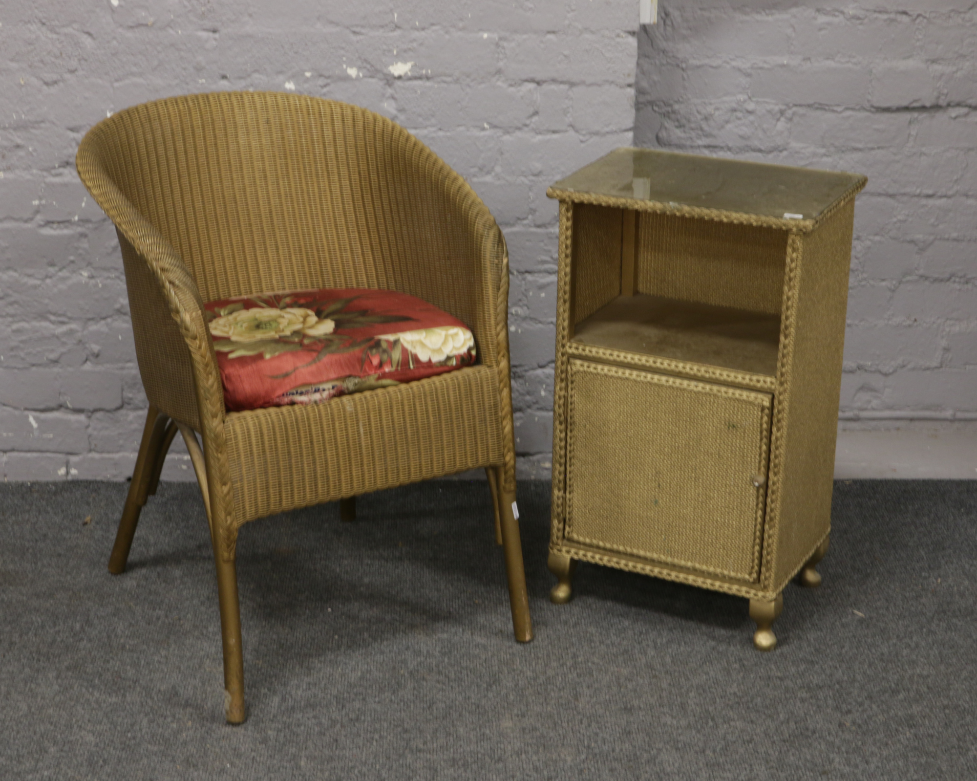 A Lloyd loom Lusty basketware chair, along with a similar bedside cabinet.