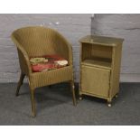 A Lloyd loom Lusty basketware chair, along with a similar bedside cabinet.