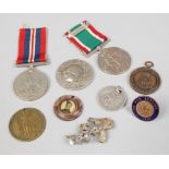A quantity of commemorative medals, along with pin badges and a Unity and Honour example.