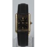 A cased silver gilt quartz Cartier wristwatch with leather strap.