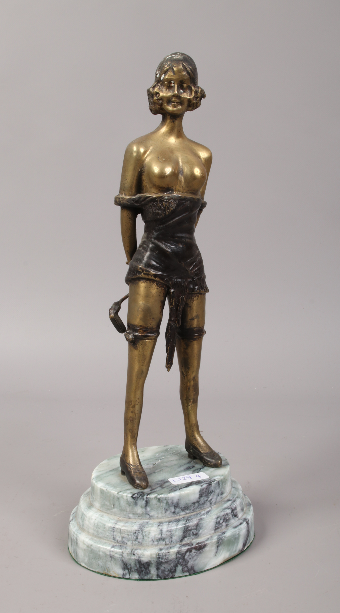 A bronze figurine of scantily clad female raised on a stepped plinth, marked F. Preiss after Bruno