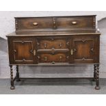 A carved oak barleytwist sideboard.