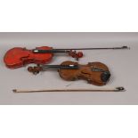 Two students violins and bows.