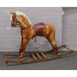 A Mamas and Papas style dappled rocking horse.